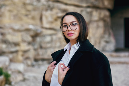 Young fashionable Asian girl on stones . Fashionable woman on a walkの写真素材