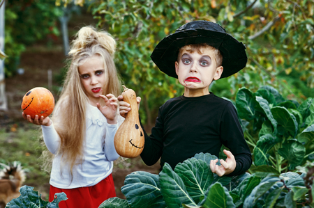 The Holiday Of Halloween! Funny kids in costumes with pumpkinsの写真素材