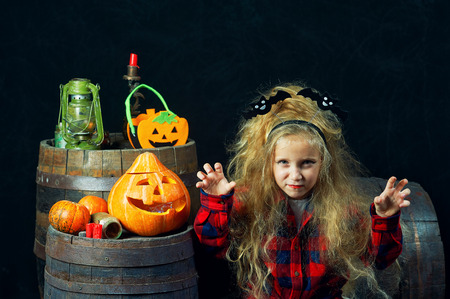 Cute little girl in the form of a witch . Halloween decorationsの写真素材
