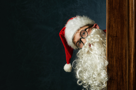 a boy dressed as Santa Claus on a dark background . Merry Christmasの写真素材