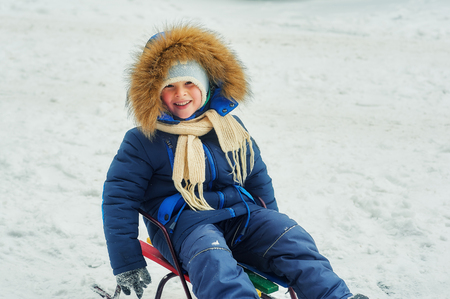 Winter portrait of a boy on a walkの写真素材