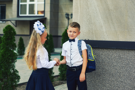 Primary school students near the school . The children do their homework on the streetの写真素材