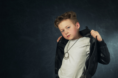 Studio portrait of a stylish boy in a leather jacket .の写真素材