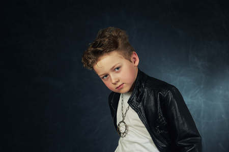 Studio portrait of a stylish boy in a leather jacket .の写真素材