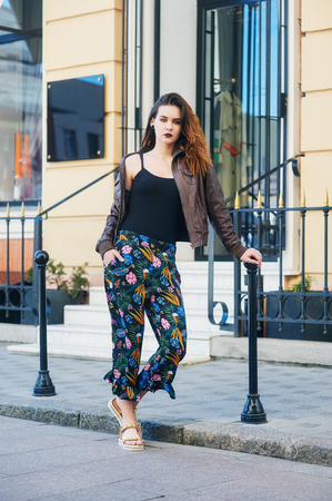 Young fashionable girl on the city street . Model posing in the cityの写真素材