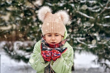 Little girl on a walk on a winter day, children's outdoor recreation
