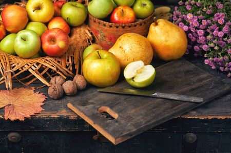 Ripe green and red apples on a wooden table. Still life of autumn fruitsの写真素材