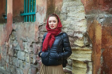 young girl on the street of the old town on an autumn dayの写真素材