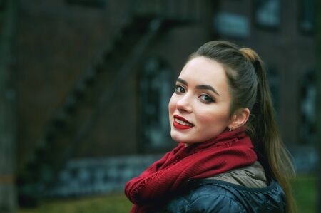 young girl on the street of the old town on an autumn dayの写真素材