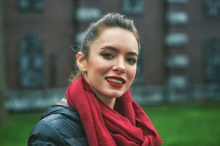 young girl on the street of the old town on an autumn dayの写真素材