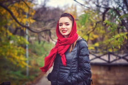 Outdoor portrait of a young woman in the autumn cityの写真素材