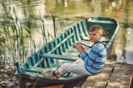 Little boy tourist with a camera . Children's tourism . Travel to exotic placesの写真素材
