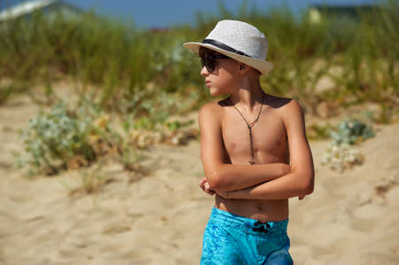 tanned boy at the resort. A child in a hat and sunglasses on vacationの写真素材