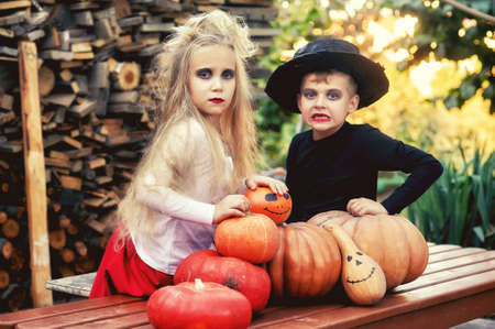 Funny kids decorated kids with pumpkins for Halloween dayの写真素材