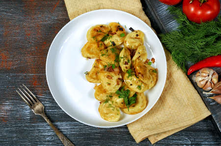 Dumplings with potatoes and onions on a plate. The view from the top