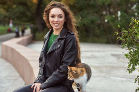 Portrait of a young beautiful girl in a leather jacket in the cityの写真素材