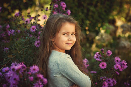 Portrait of a cute little girl on a walkの写真素材