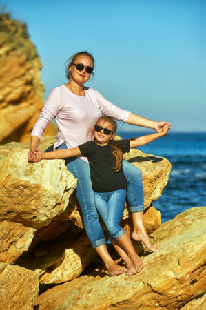 Mother and daughter on the sea coast on an autumn dayの写真素材