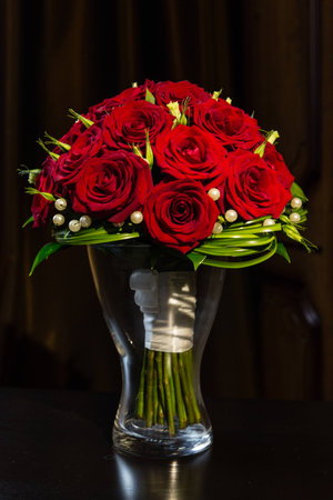 bridal bouquet of red roses in a vaseの写真素材