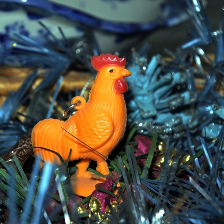 the symbol of the new 2017 rooster on the background of Christmas tree and boxes with giftsの写真素材