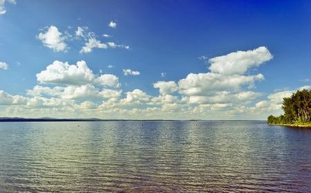 quiet lake Uvildy early in the morning, clear water, clear bottom, South Ural, in the distance are seen the Ural mountainsの写真素材