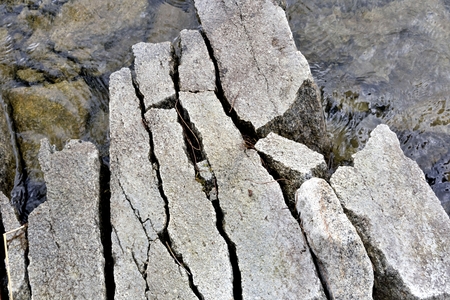 rocky shore of the lake,cracked along the granite boulders