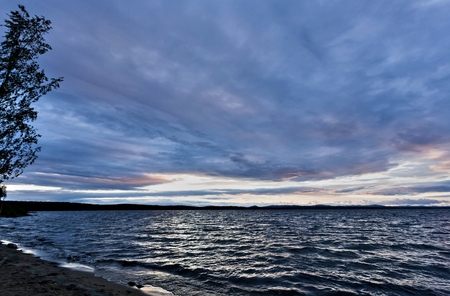 dark blue evening cloudy sky over the lake, wind, waves, watercolor sky, heavy Shine of waterの写真素材
