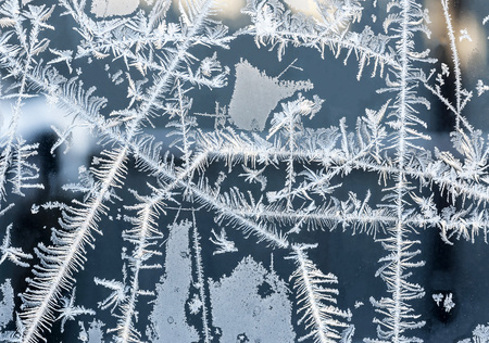 beautiful frosty patterns on glass in winterの写真素材