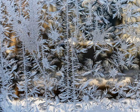 texture of frosty patterns on the window glass, winter backgroundの写真素材