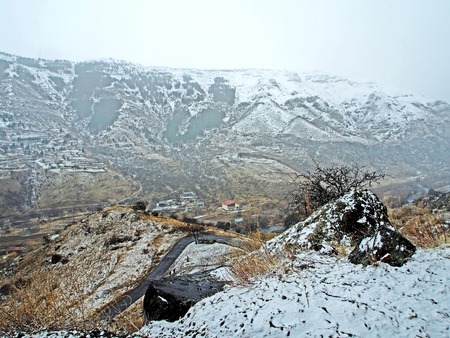 view of the Kura river valley from Vardzia monastery during spring snow and fogの写真素材