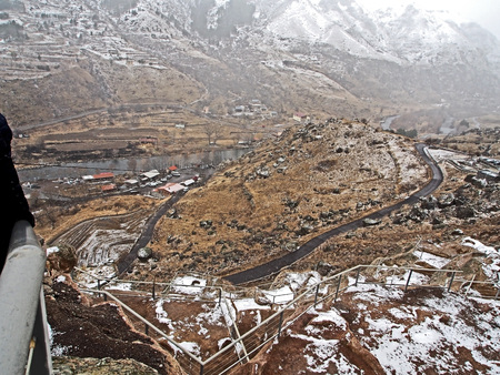 view of the Kura river valley from Vardzia monastery during spring snow and fog