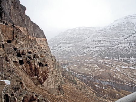 view of the Kura river valley from Vardzia monastery during spring snow and fogの写真素材