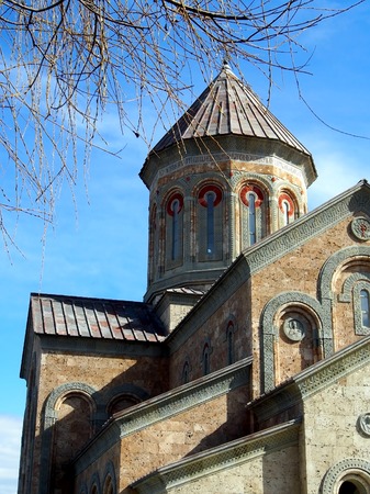 ancient monastery of Bodbe in Georgia lit by the morning sun, is being restored
