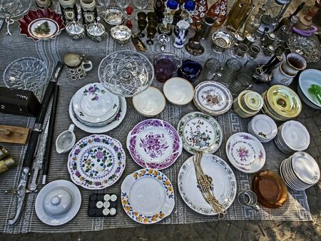 old porcelain plates with beautiful pictures at the flea market in Tbilisiの写真素材