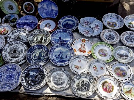 old porcelain plates with beautiful pictures at the flea market in Tbilisiの写真素材