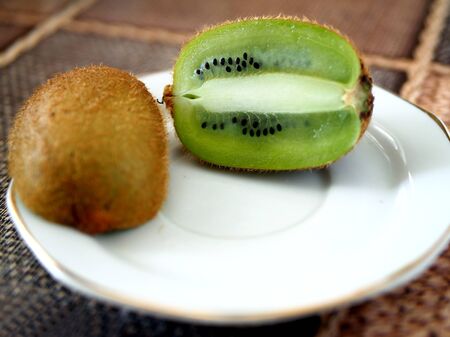 ripe kiwi fruit cut in half on a plate, macroの写真素材