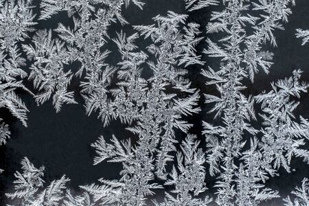 Frosty natural pattern on a winter window, texture of frosty patterns, dendritic image structureの写真素材