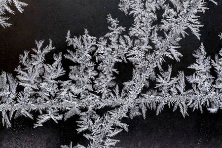 Frosty natural pattern on a winter window, texture of frosty patterns, dendritic image structure