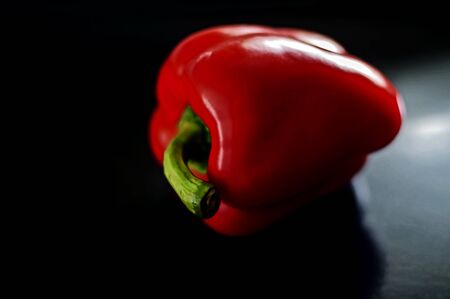 organic red pepper on a dark wooden background