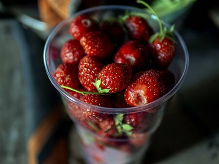 red ripe strawberries in a glass on the table, macroの写真素材