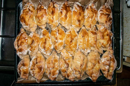 hot rosy fresh pies from the oven on a baking sheet close up