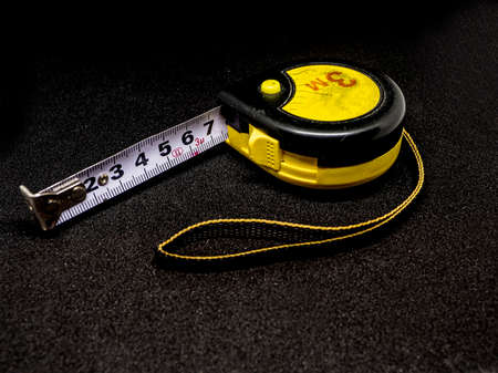 centimeter measuring tape on a black background, length 3 meters