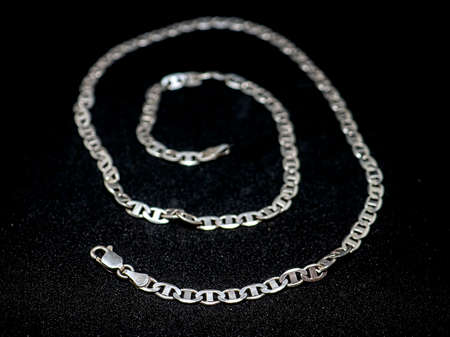 shiny silver chain on a black background, macro, narrow focus area