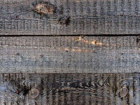 bright texture of a shield made of wet boards on the lake shore after rainの写真素材