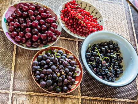 different berries in plates on the table, excellent taste and benefitsの写真素材