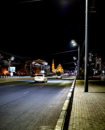 deserted illuminated night road in the city, bridge over the river, Chelyabinsk, Russiaの写真素材