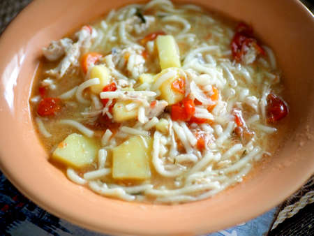 plate of noodle soup on the tableの写真素材