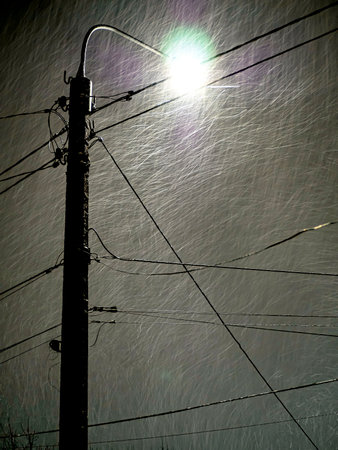 bright light of a street lamp in a snowstorm