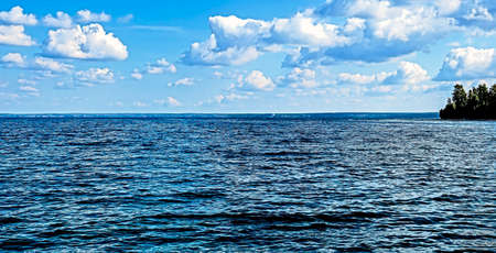 blue sky with white clouds over lakeの写真素材