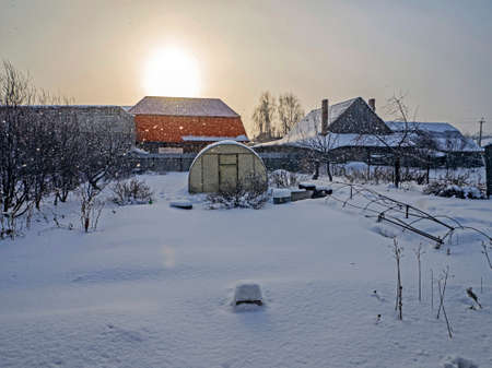 view of a winter rural landscape during a snowfall